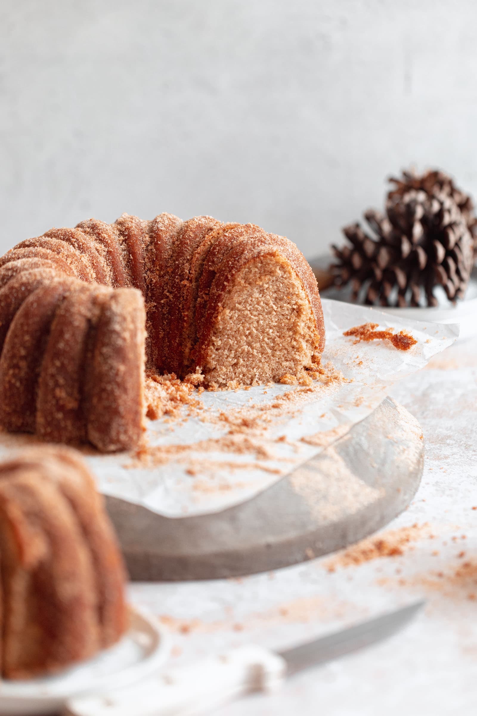 apple cider donut bundt cake on a stand