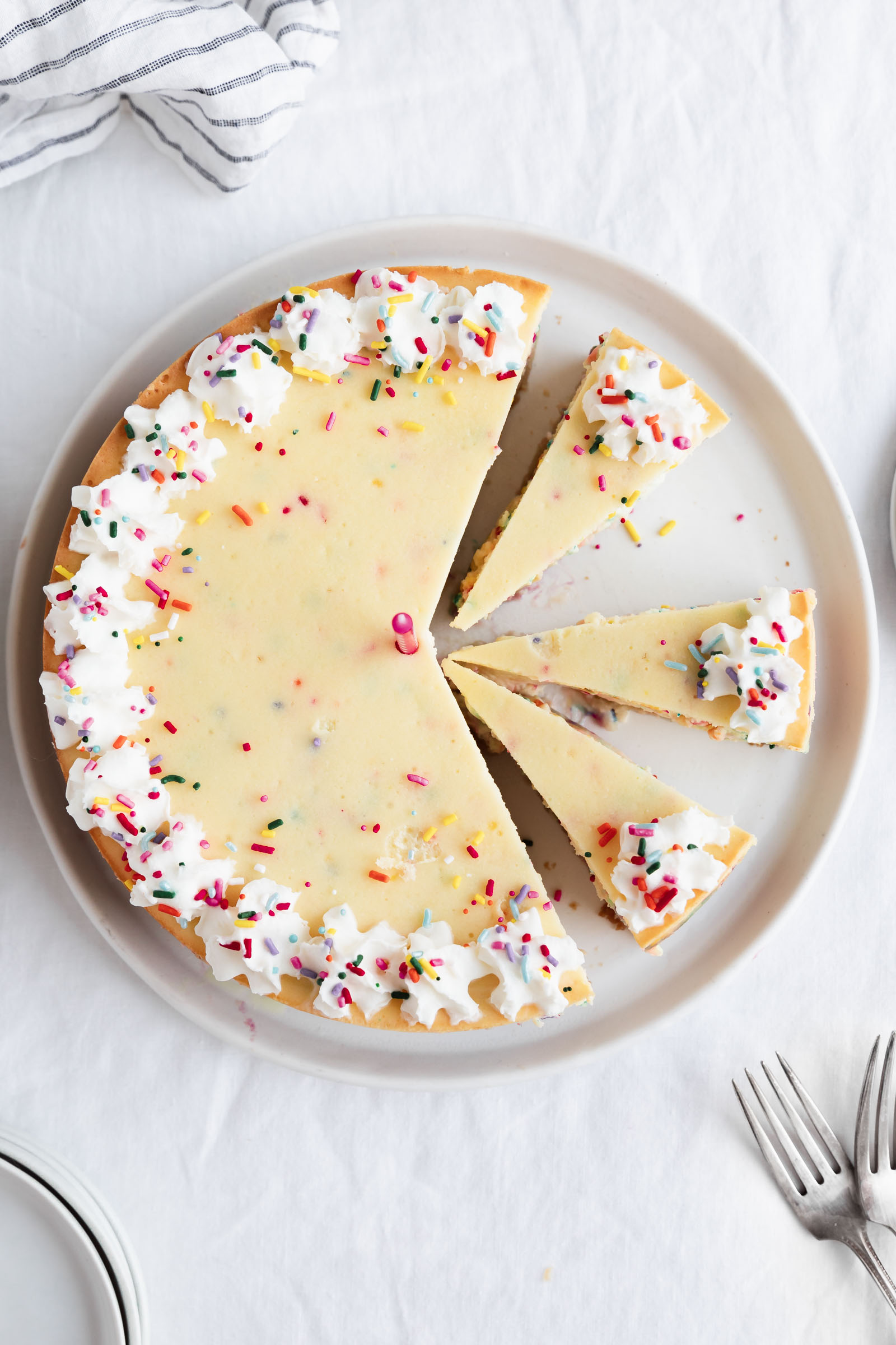 overhead shot of birthday cheesecake with whipped cream