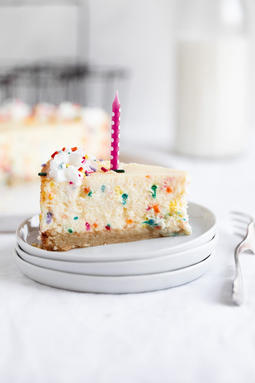slice of easy birthday cheesecake with candle
