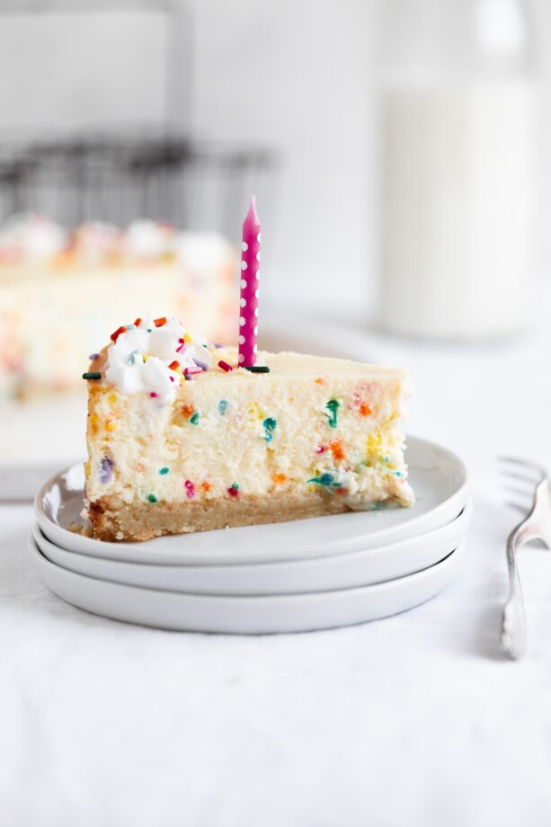 slice of easy birthday cheesecake with candle