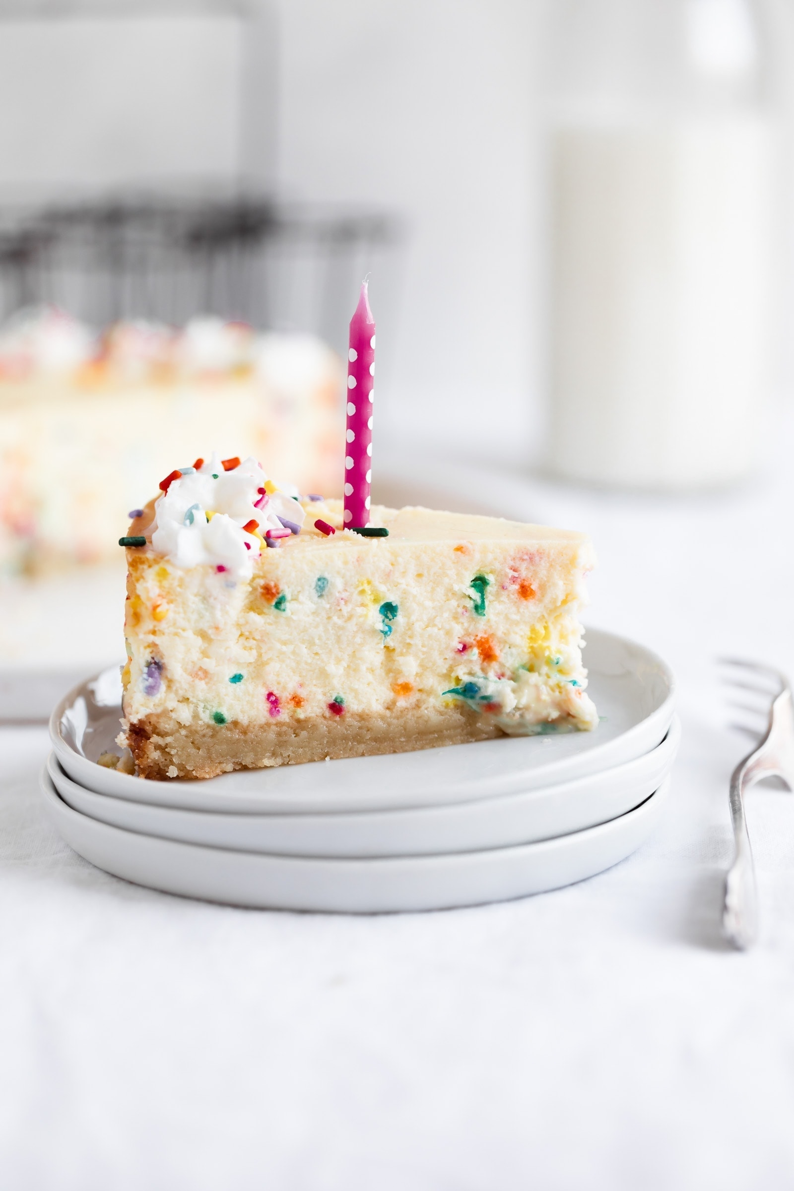 slice of easy birthday cheesecake with candle