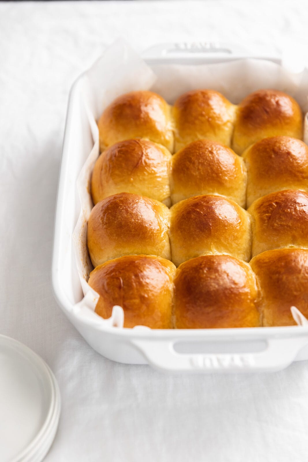 brioche dinner rolls in a white pan