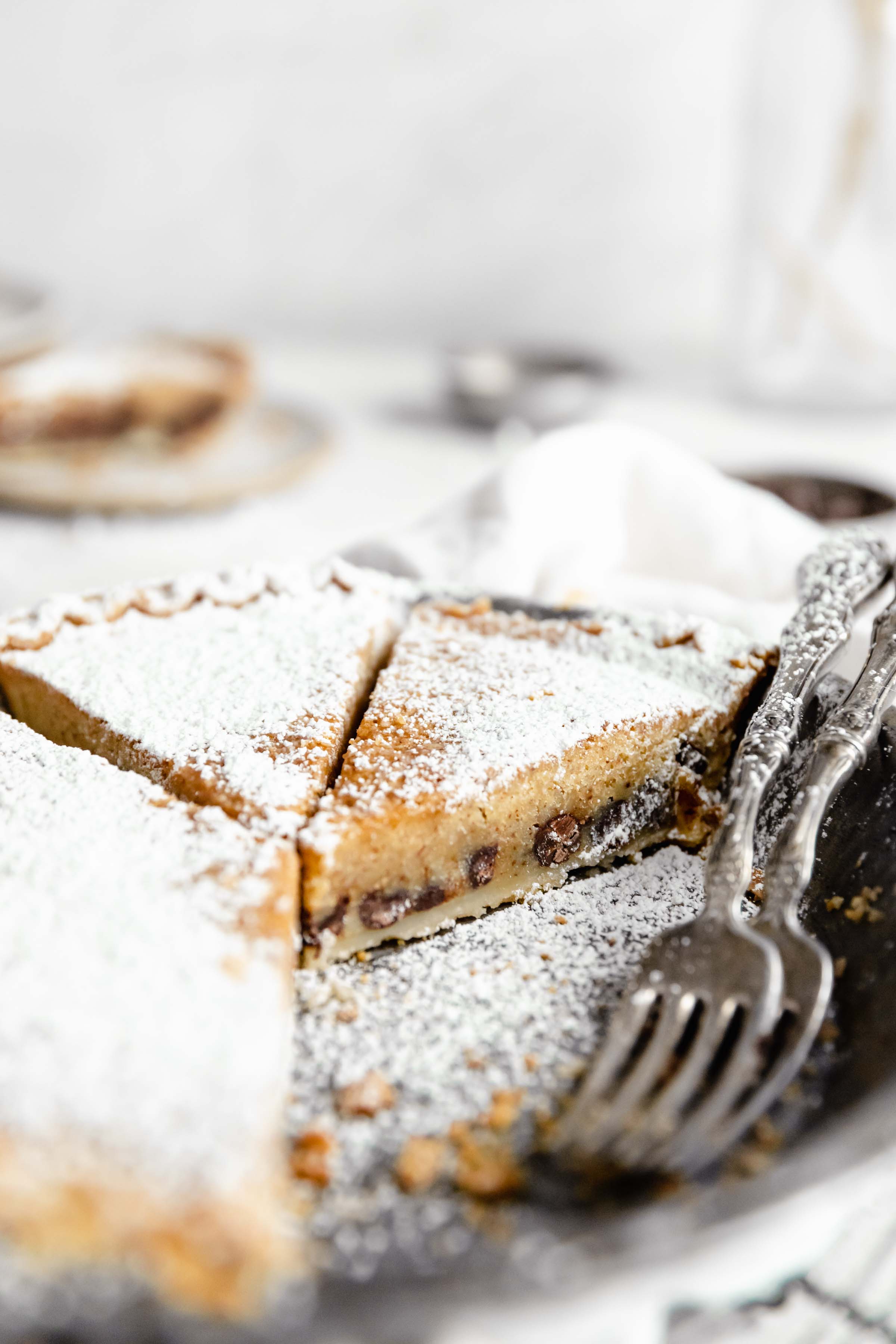 pie pan of chocolate chip cookie pie with two forks