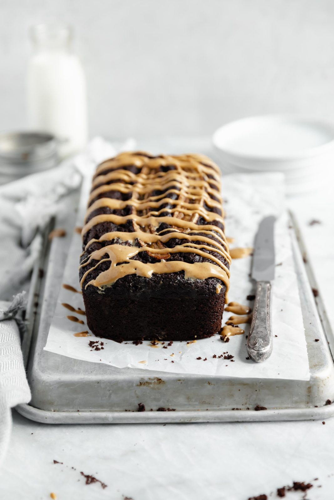 easy peanut butter chocolate banana bread loaf with a healthy drizzle of peanut butter on top