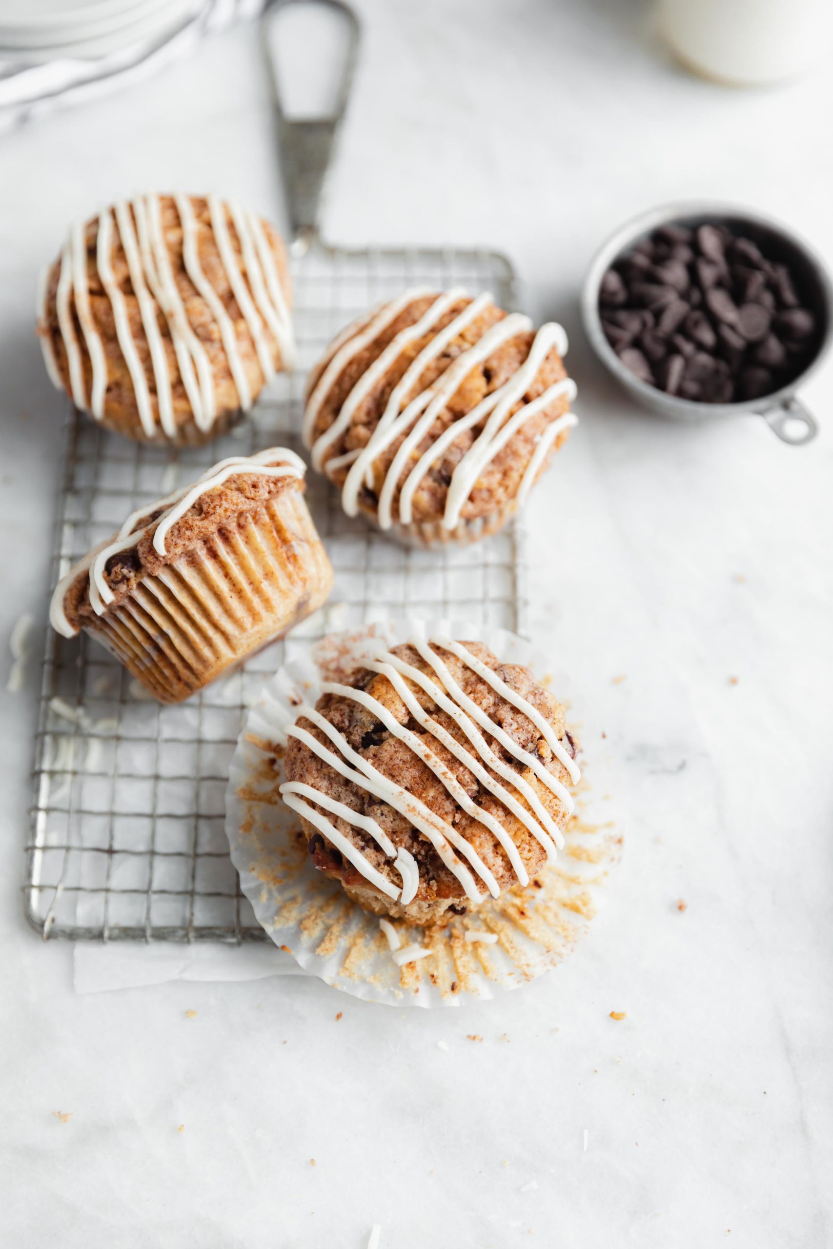 buttery cinnamon swirl chocolate chip muffins drizzled with icing