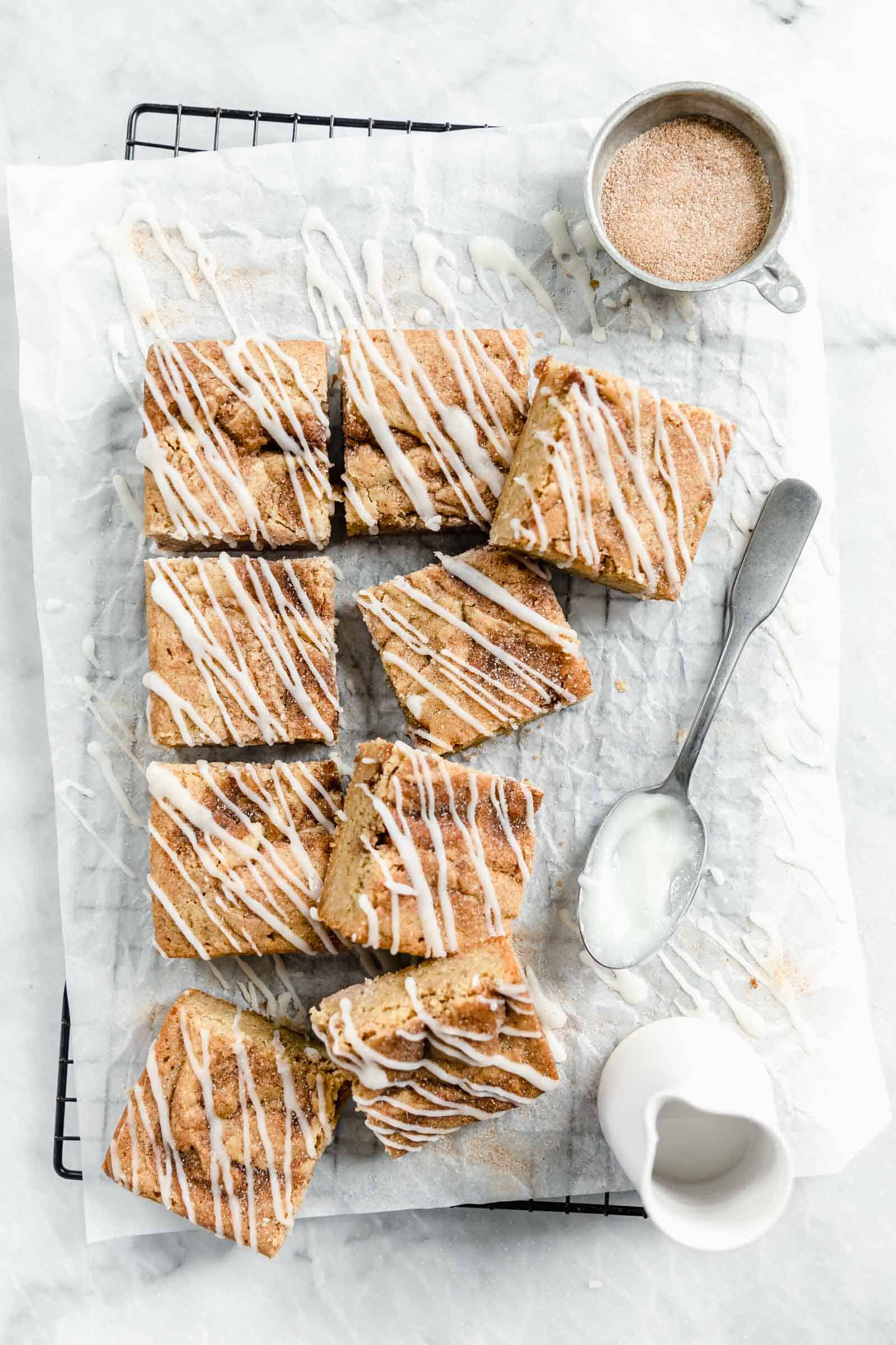 cinnamon roll blondies on parchment paper