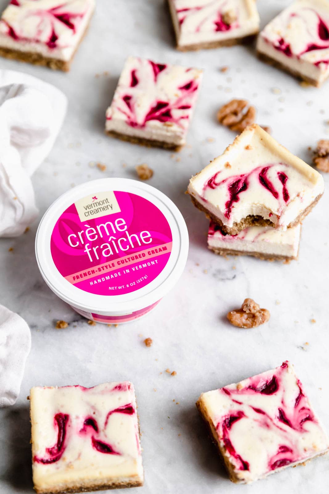 Walnut Cranberry Cheesecake Bars with container of creme fraiche