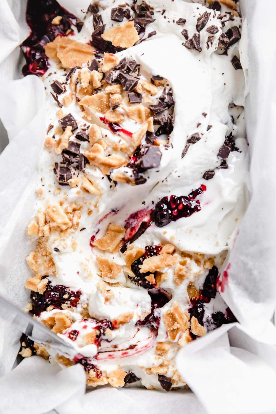 This creamy vanilla ice cream with fat blackberry swirls, buttery waffle pieces, and chocolate chips has us in heaven. Whip up this no churn blackberry waffle chocolate chip ice cream in minutes and skip the line at the ice cream shop.