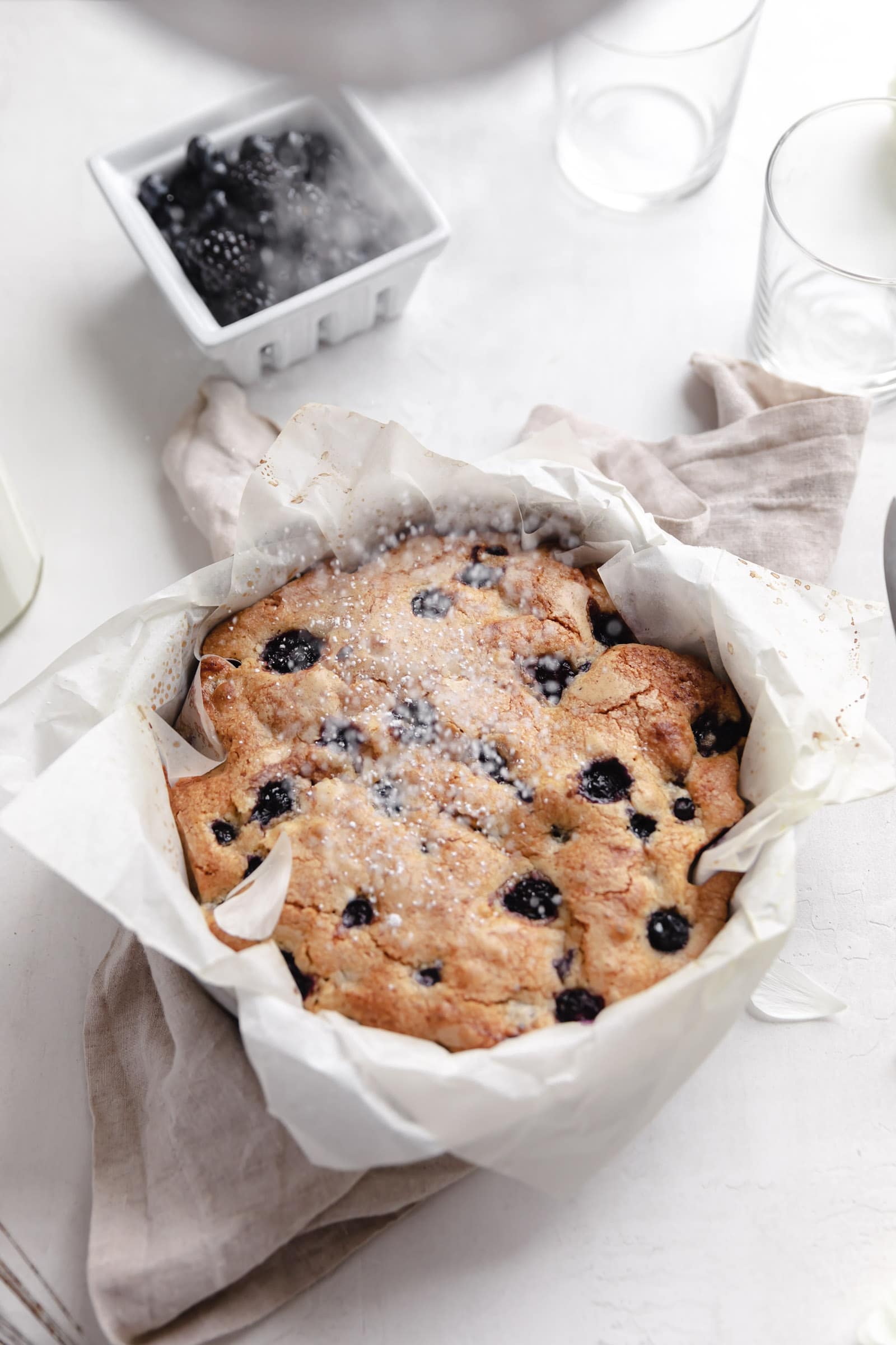 olive oil cake with powdered sugar and berries