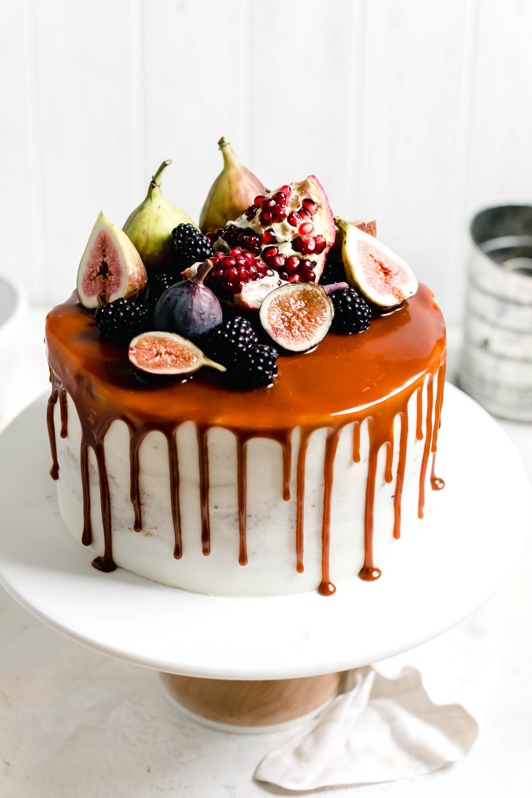Pumpkin cake with cream cheese frosting on a cake stand