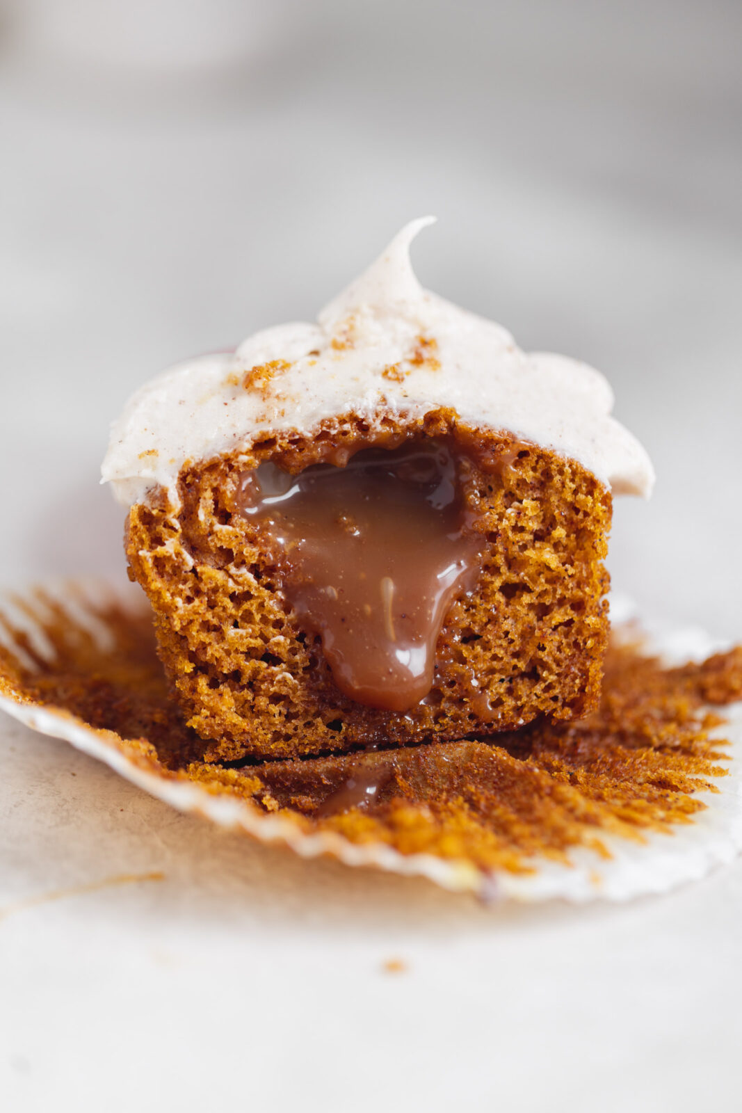 single serve pumpkin cupcake with caramel and cream cheese frosting