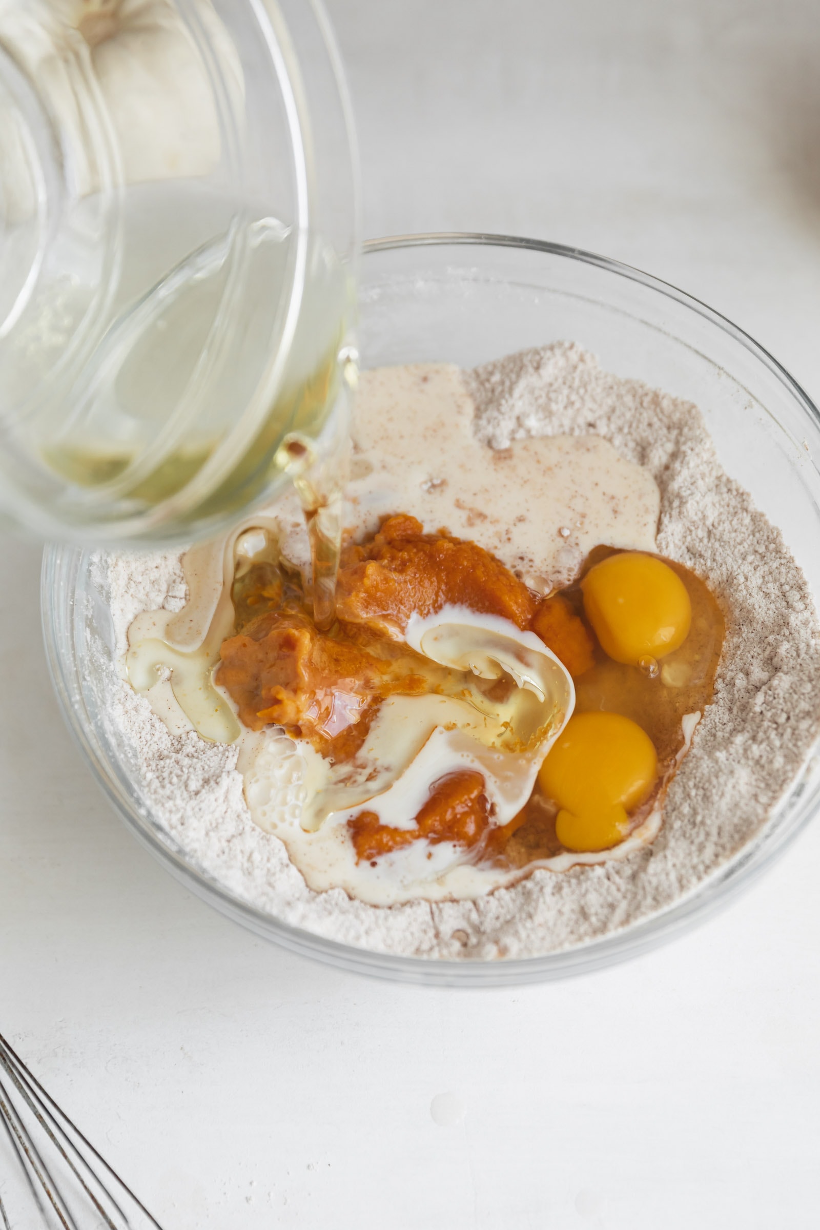 oil going into a pumpkin batter