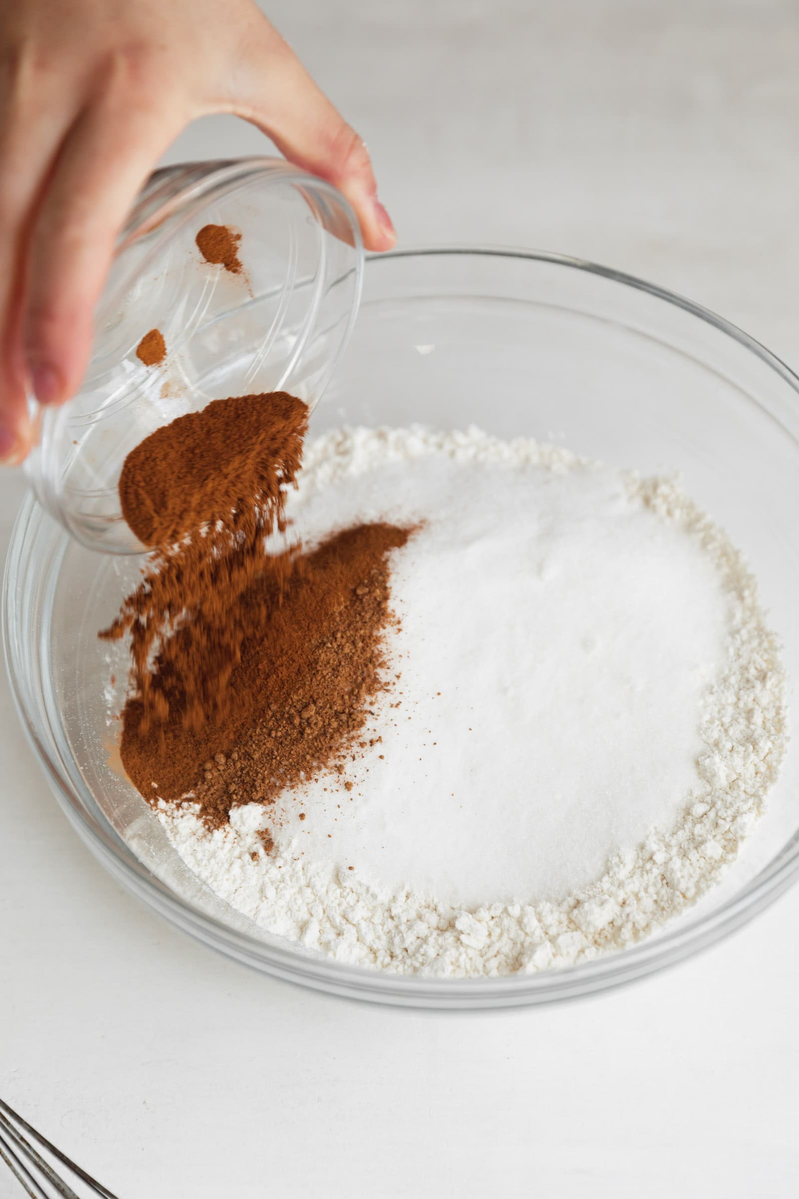 spices going into a bowl of flour
