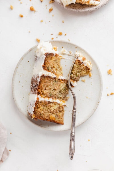 zucchini layer cake with cream cheese icing on a plate